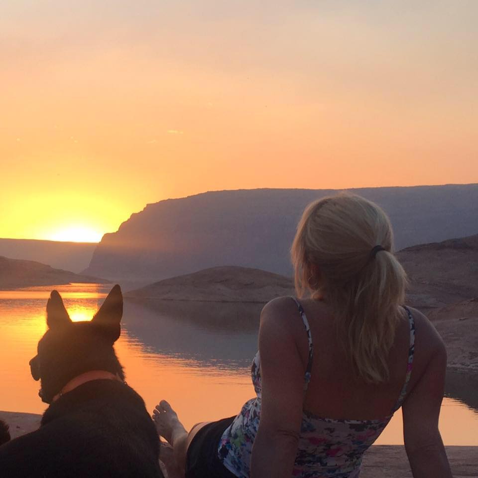 Ren and her dog looking off into the sunset